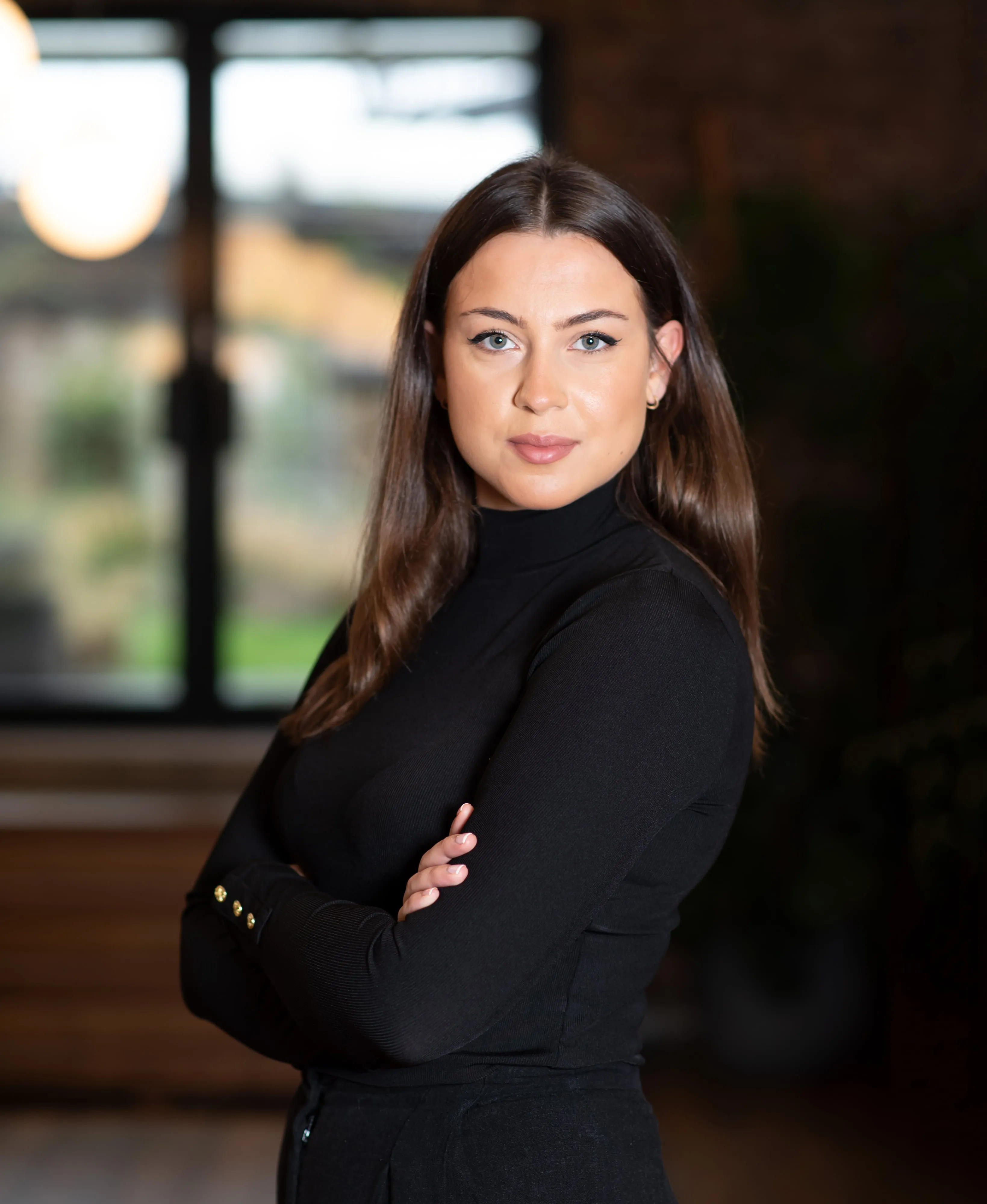 Woman in black turtleneck professional headshot