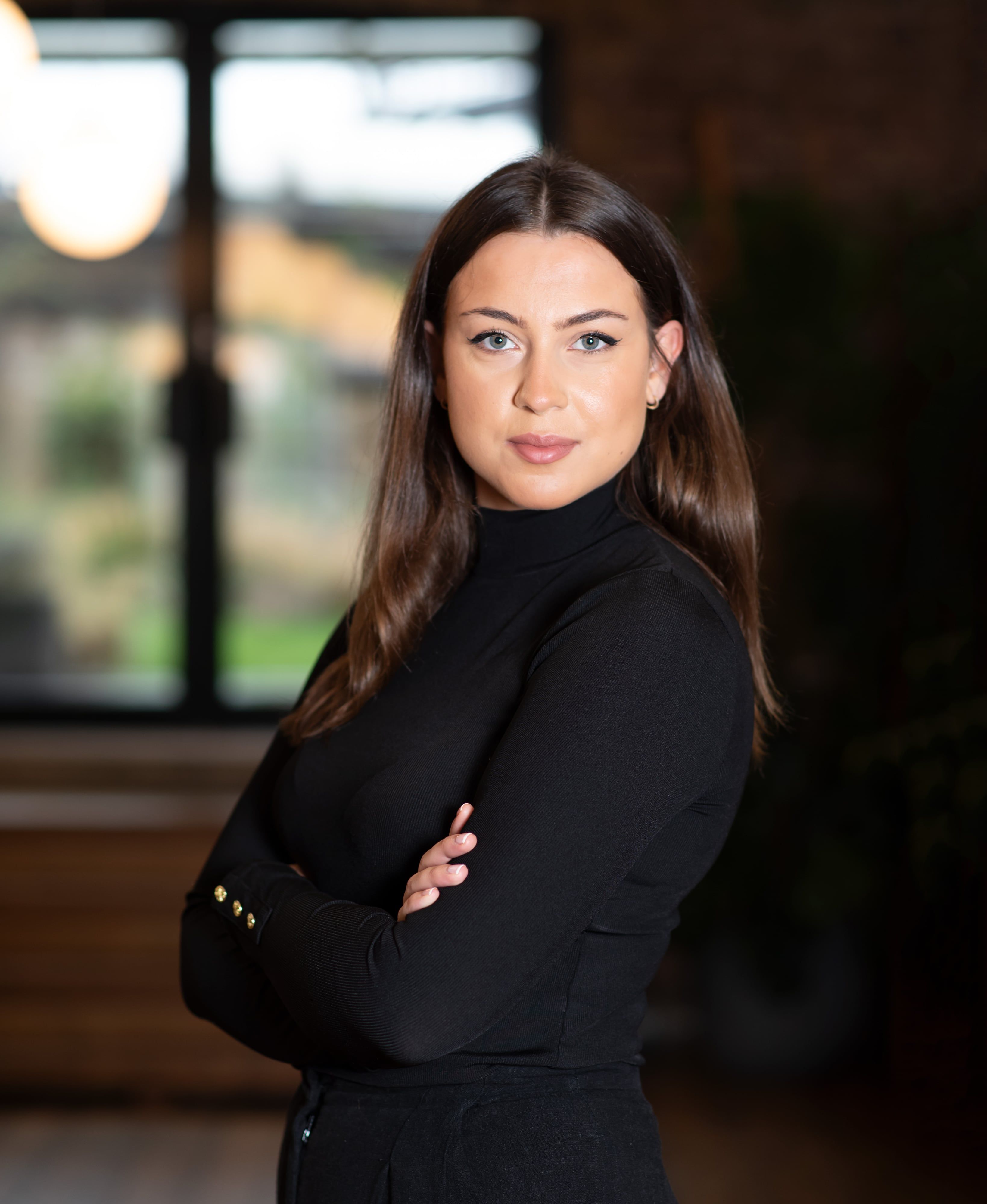 Woman in black turtleneck professional headshot