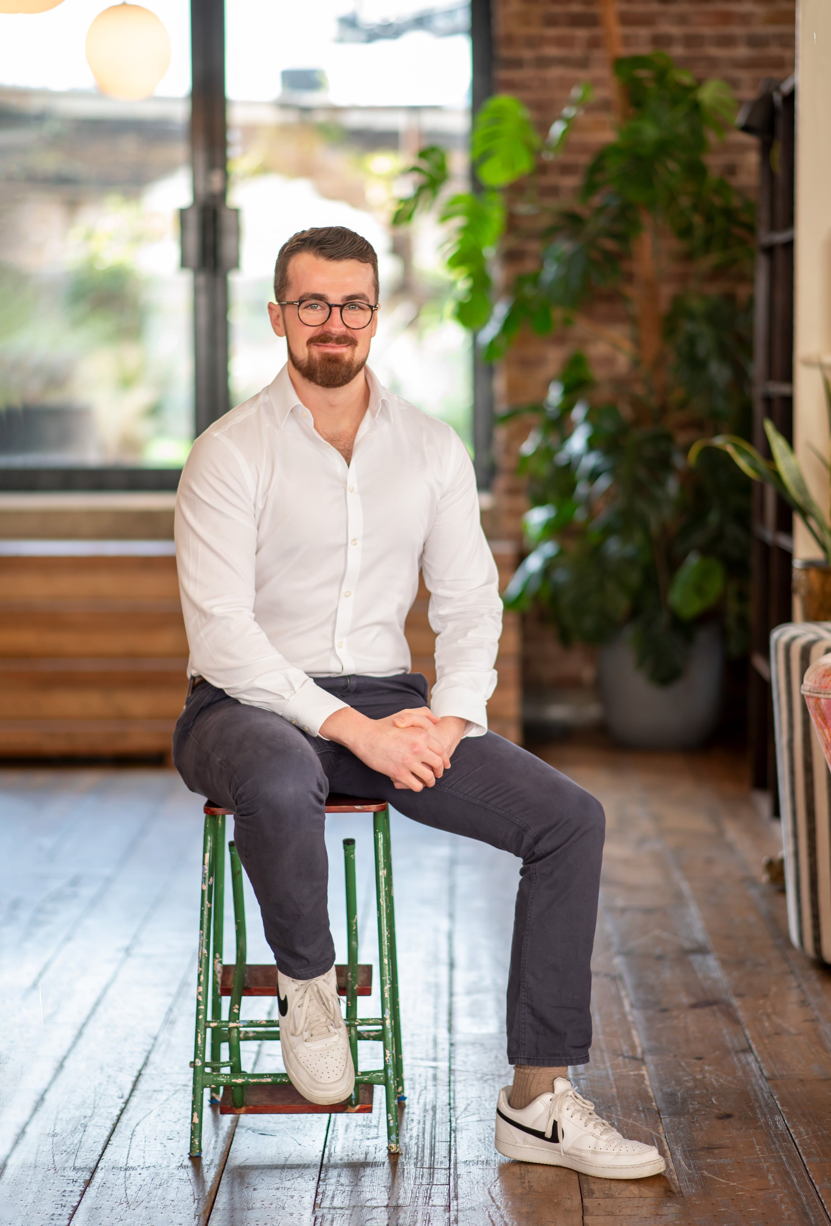 Confident professional headshot in office environment