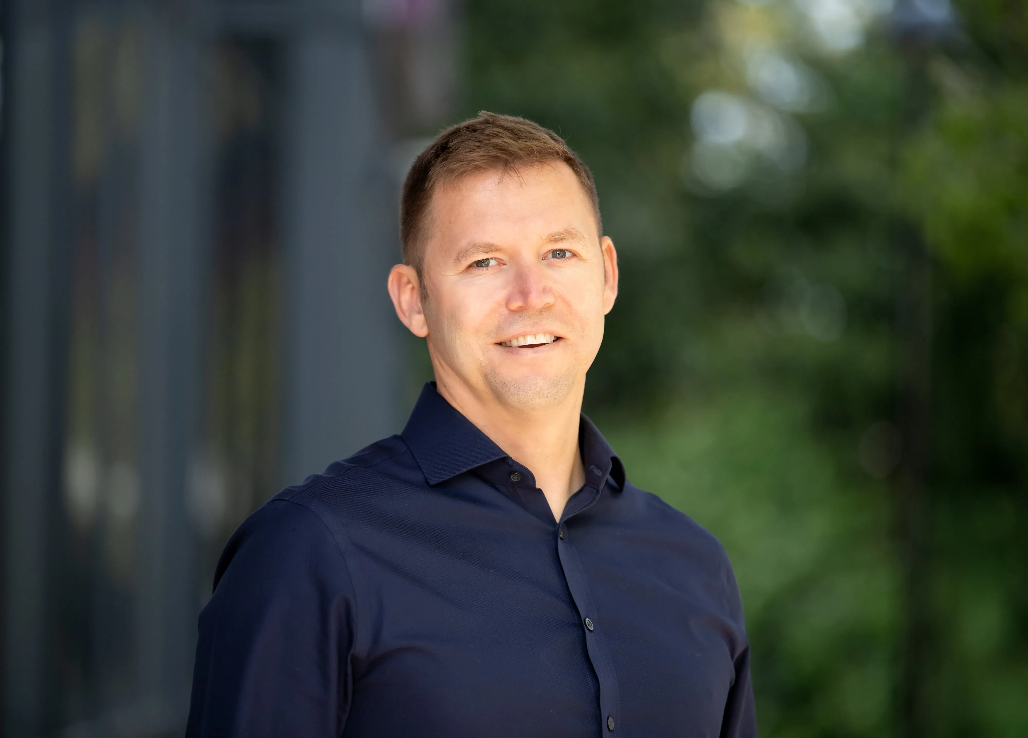 Polished corporate headshot in soft natural light