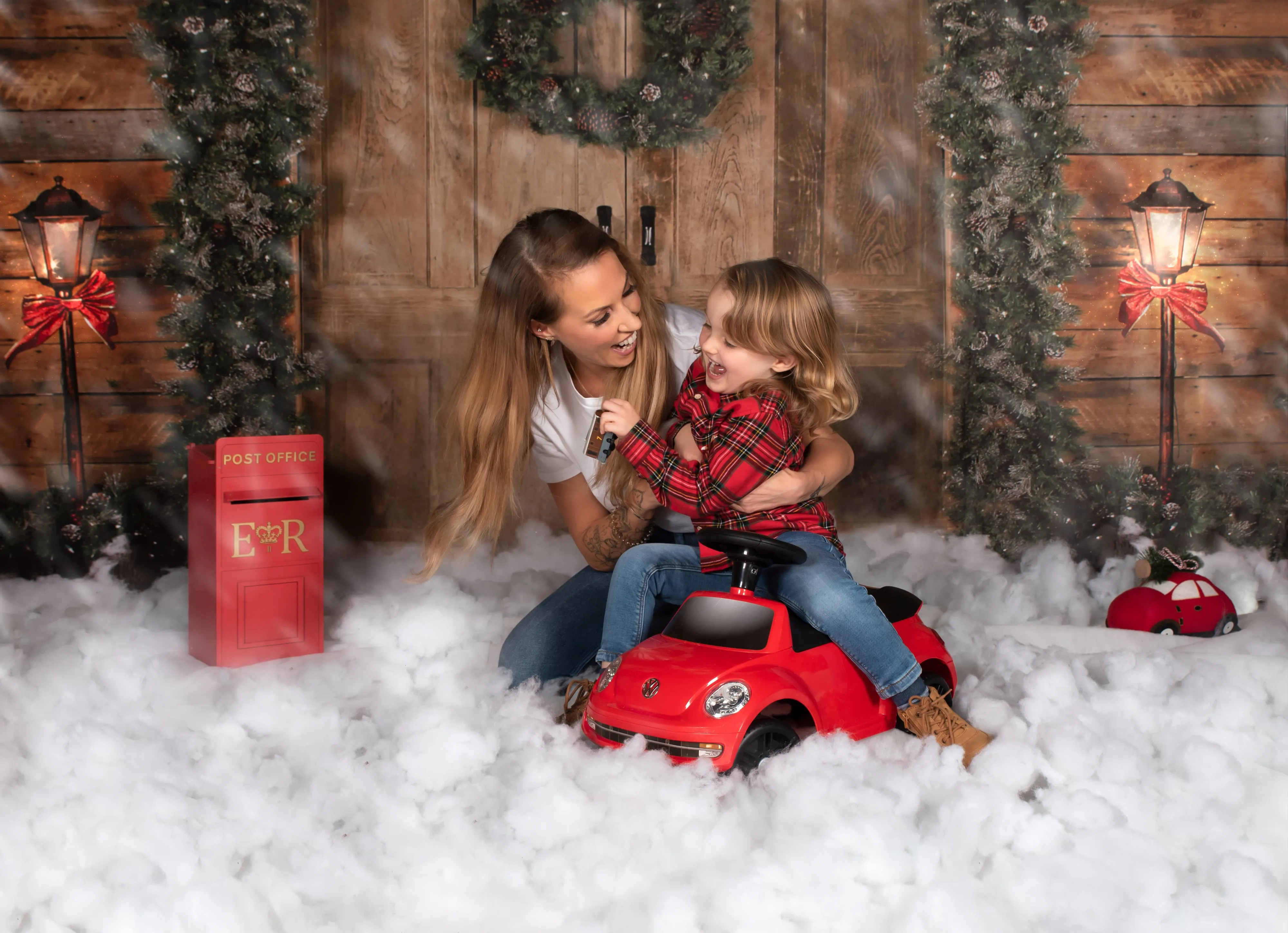 Placeholder — Christmas studio mother and daughter on red car