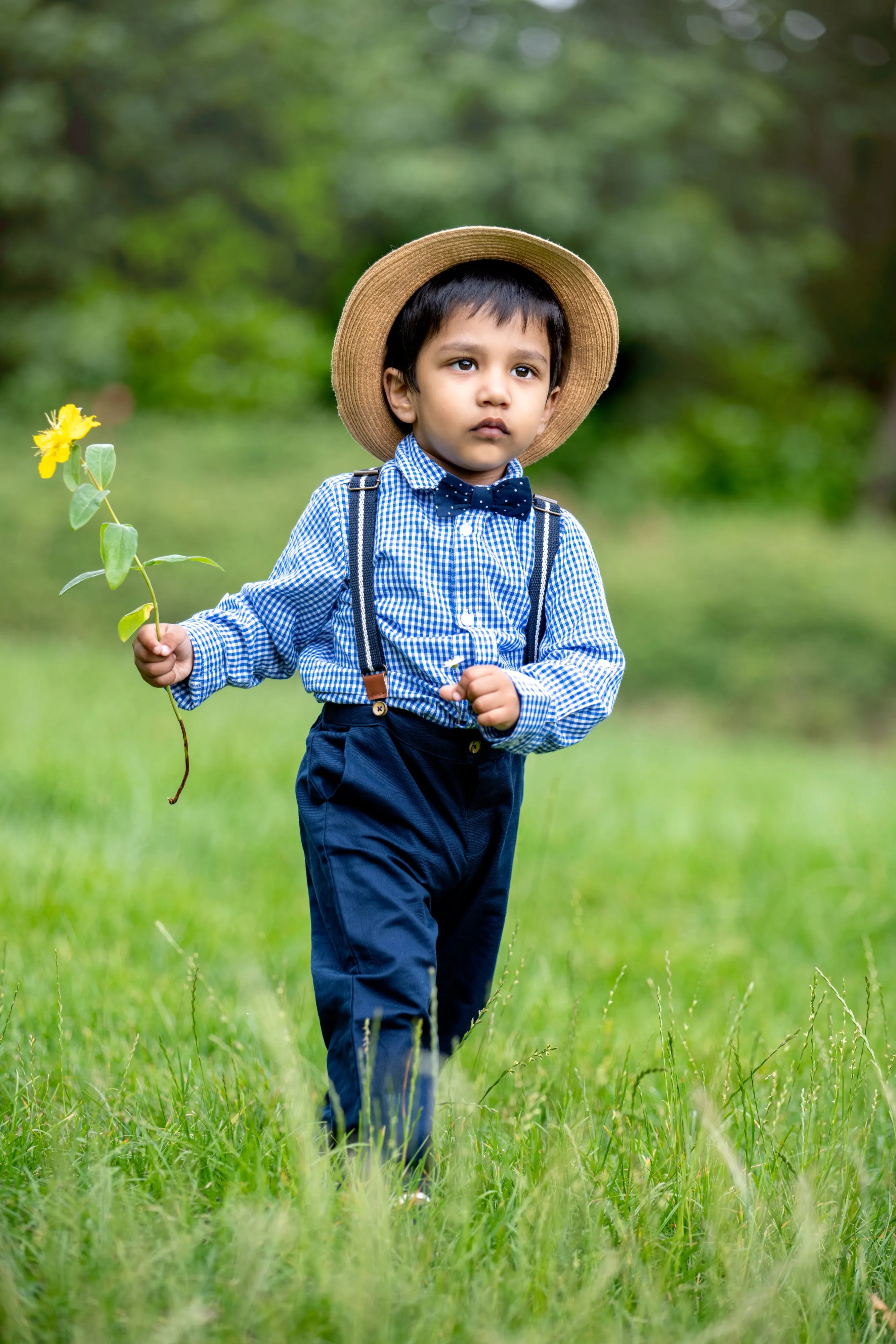 Father lifting laughing toddler above his head outdoors