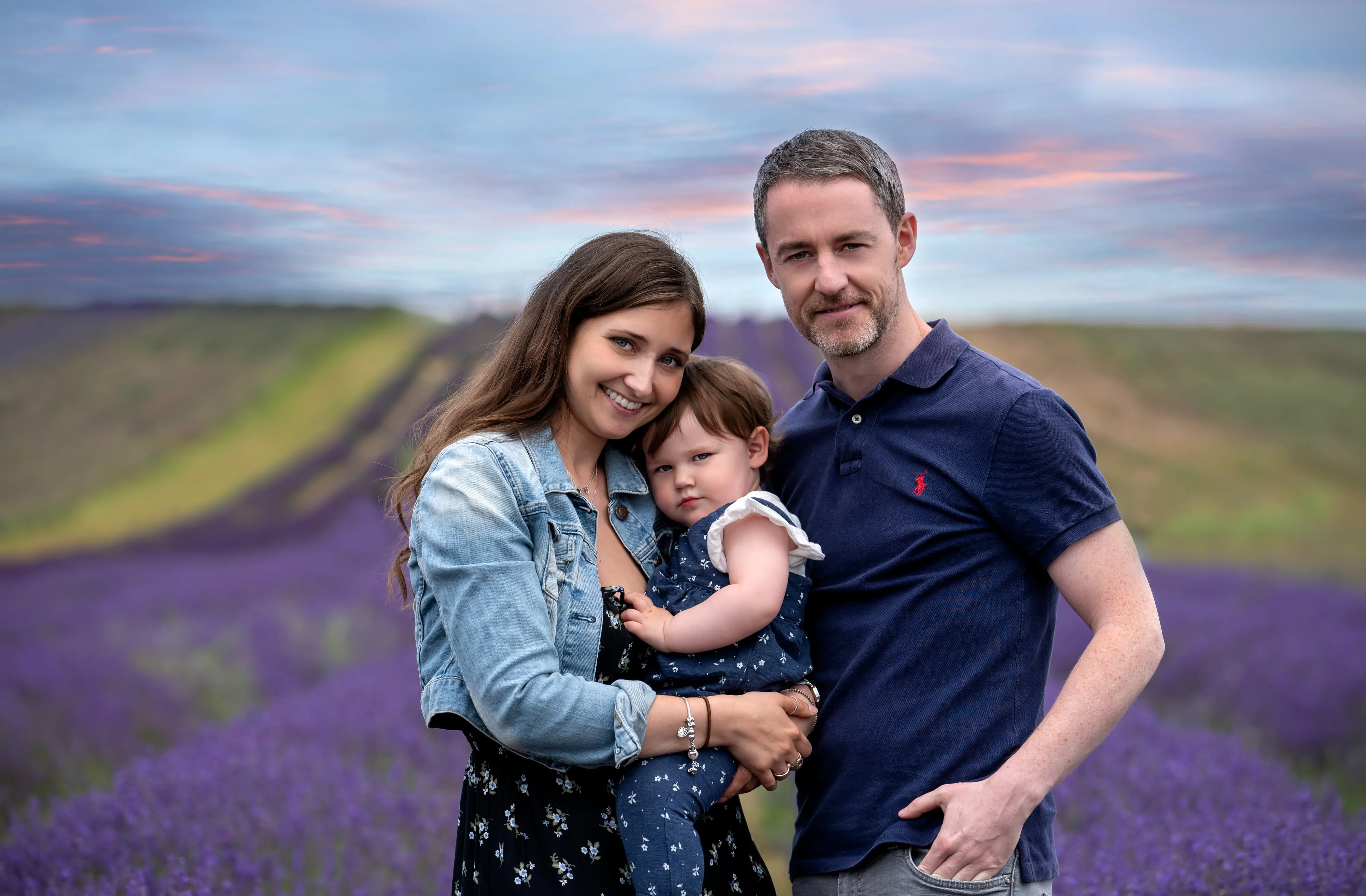 Family of three in a lavender field at sunset