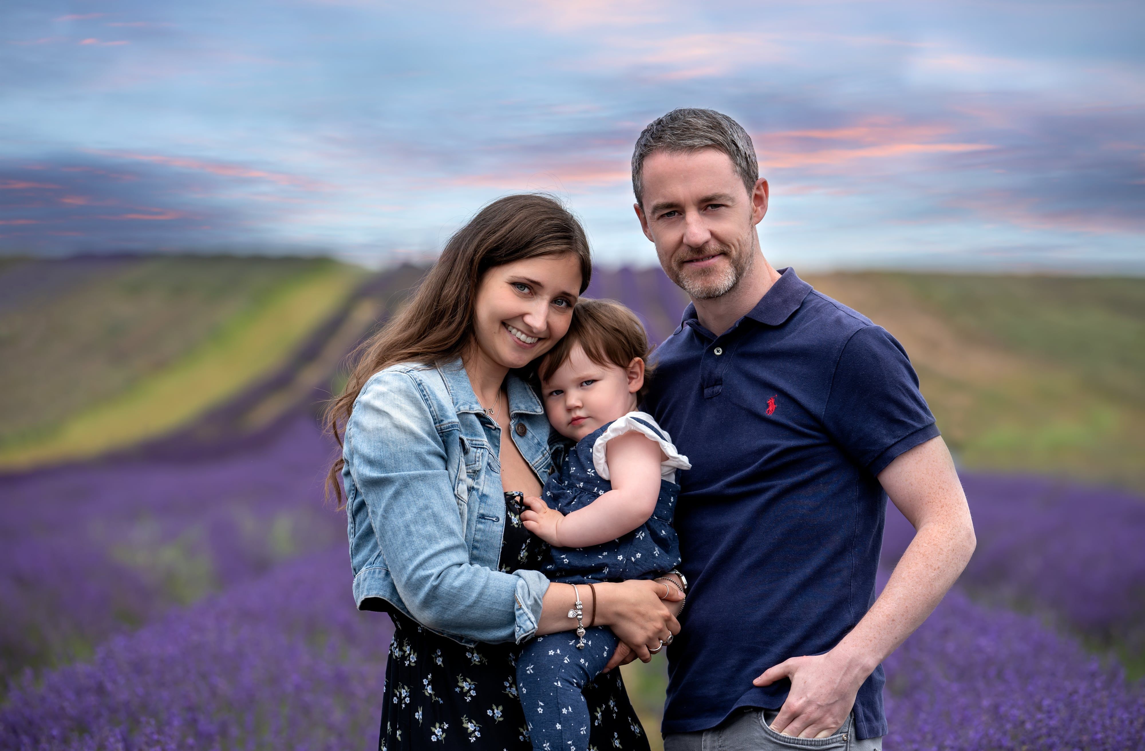 Family of three in a lavender field at sunset