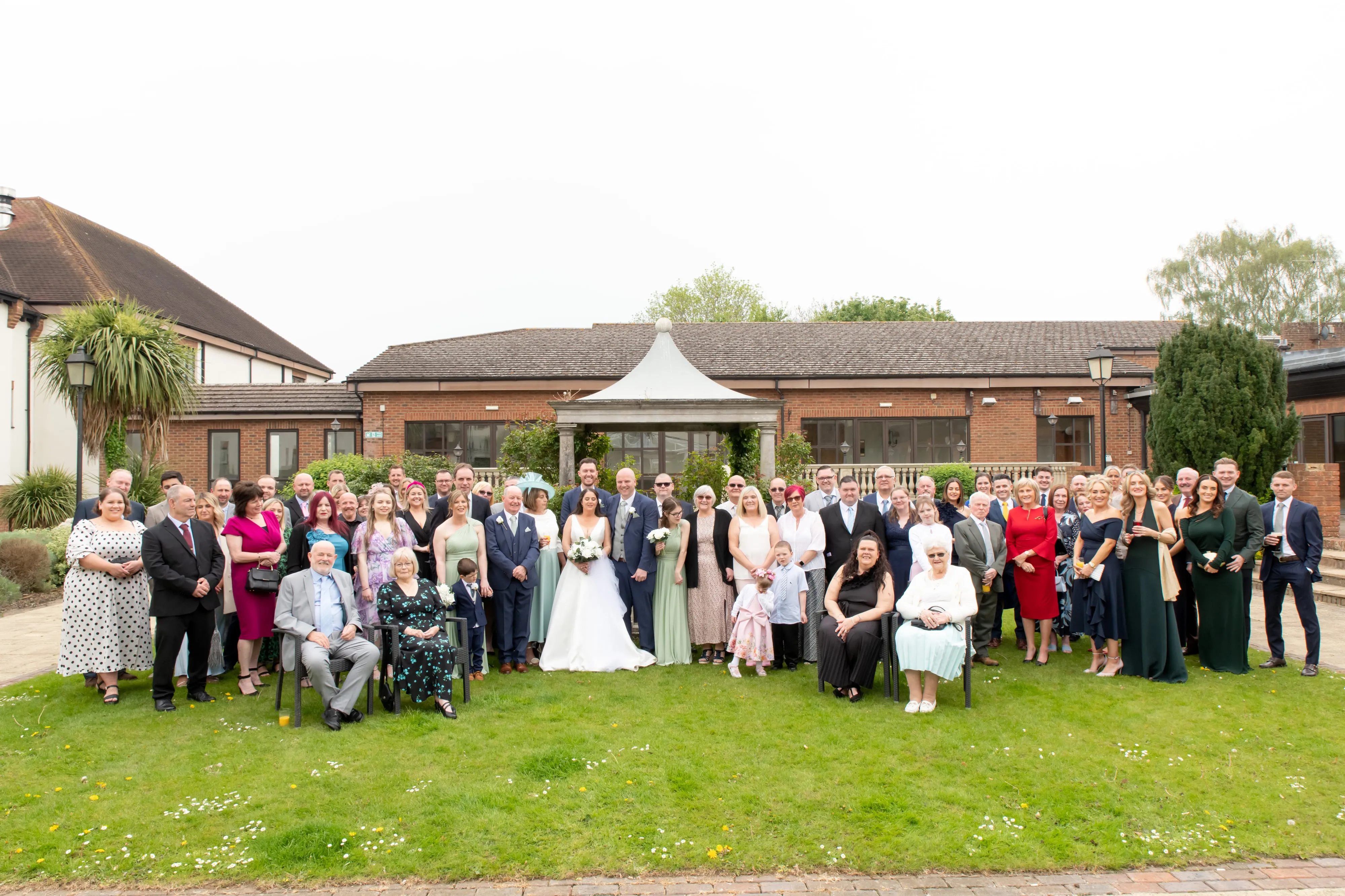 Large wedding party group photo by Belfry pavilion gazebo and gardens
