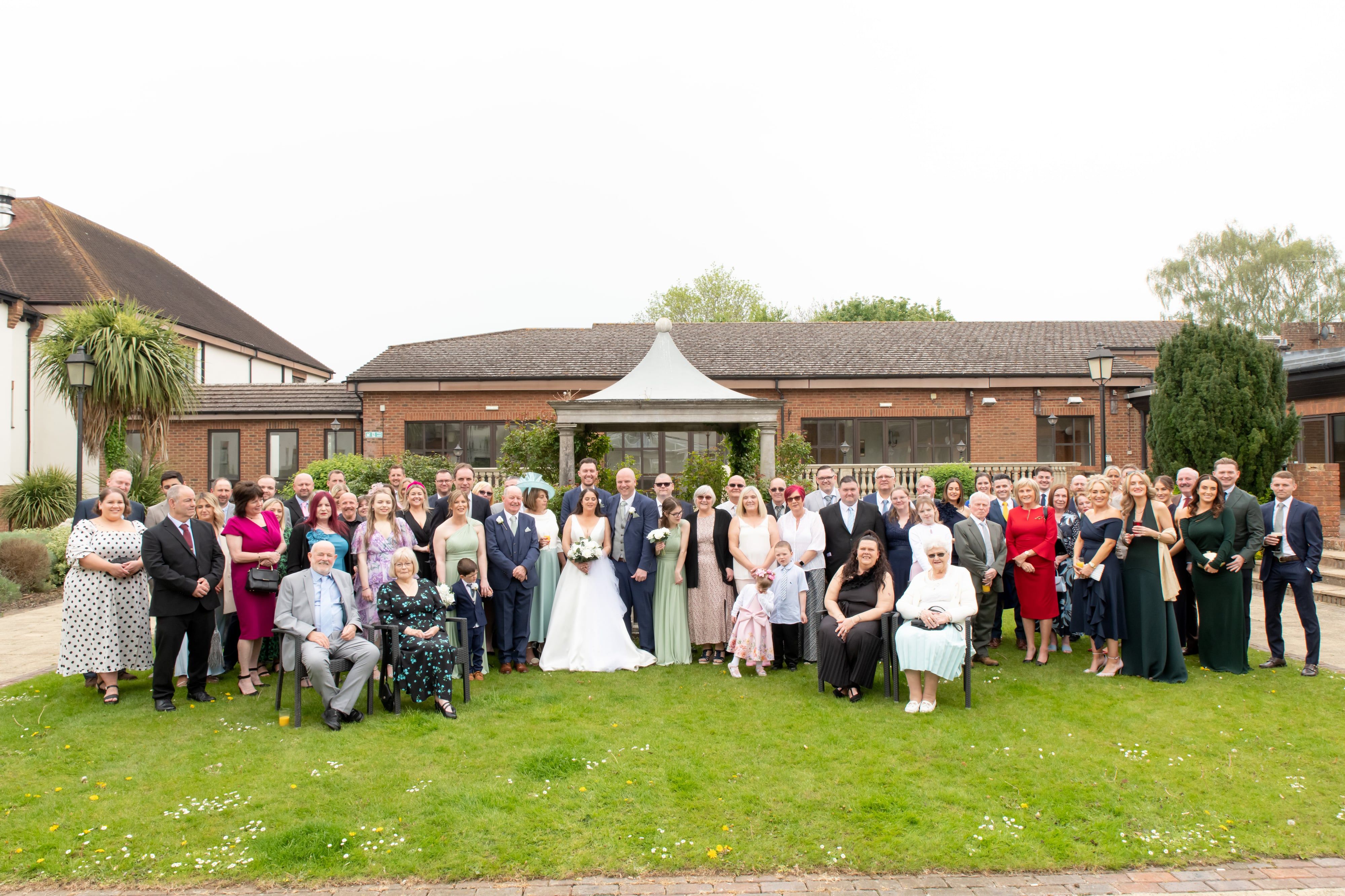 Large wedding party group photo by Belfry pavilion gazebo and gardens