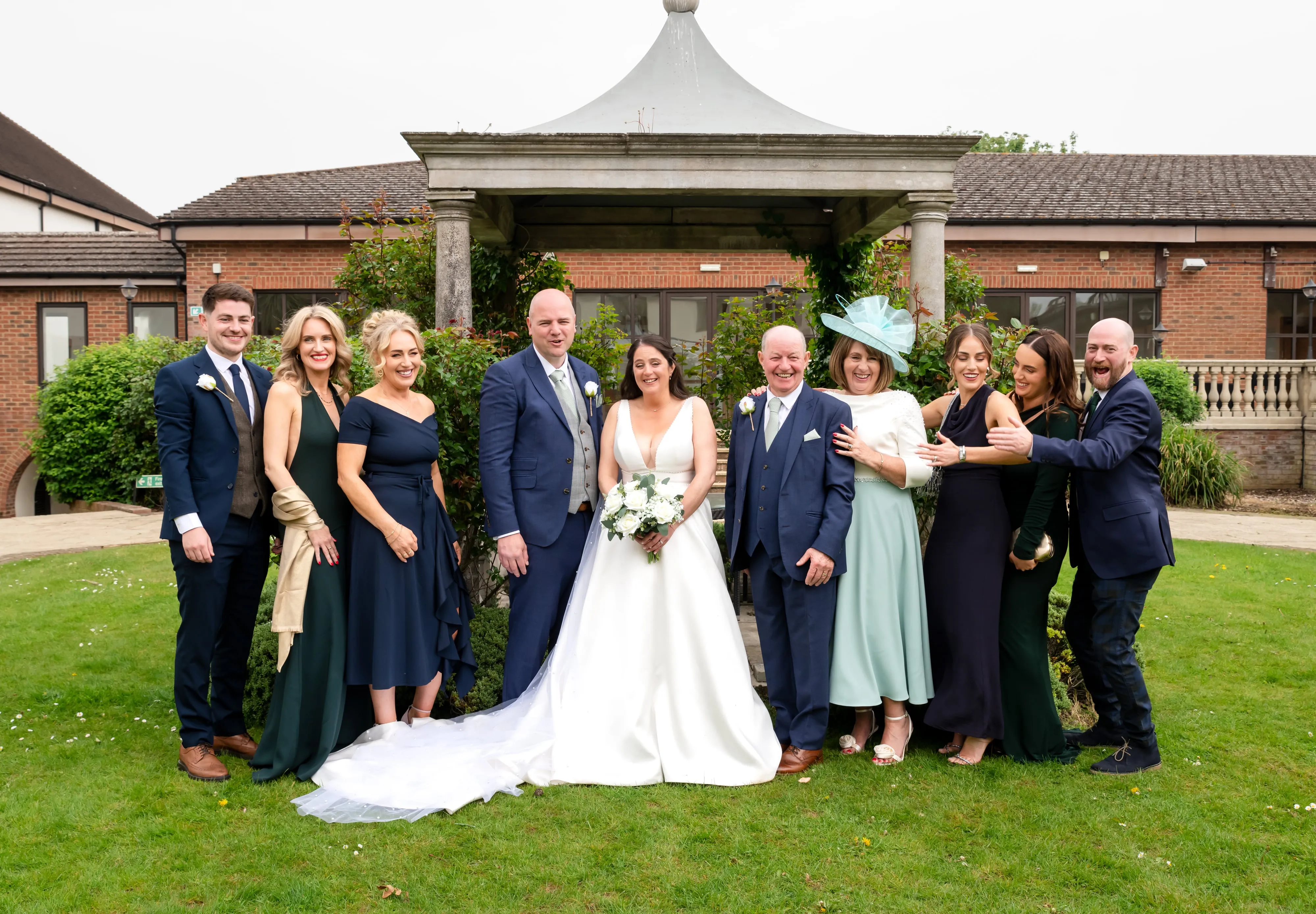Extended family group portrait by stone pavilion at Oxford Belfry Hotel