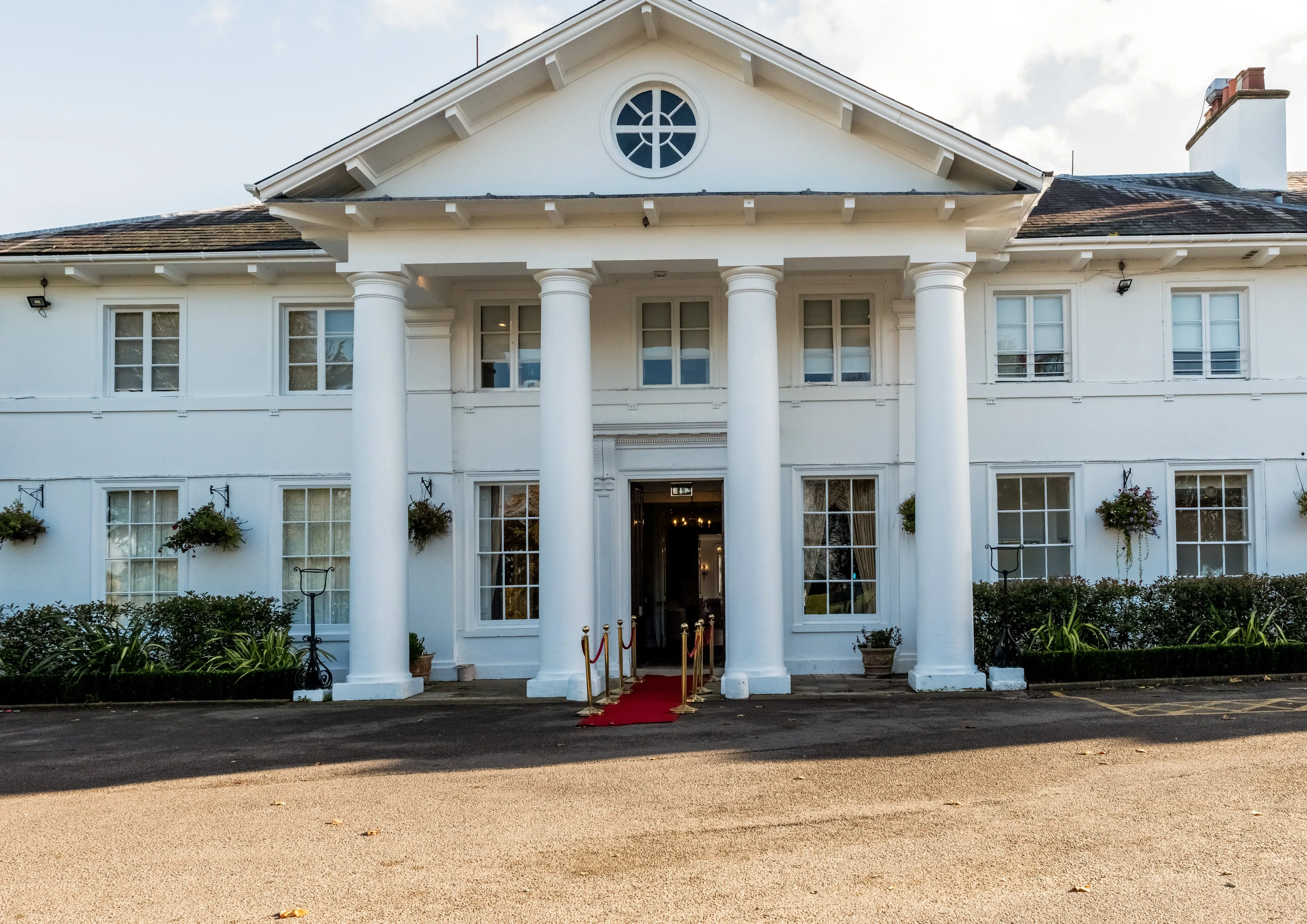 Dyrham Park country house facade with bridal party arriving