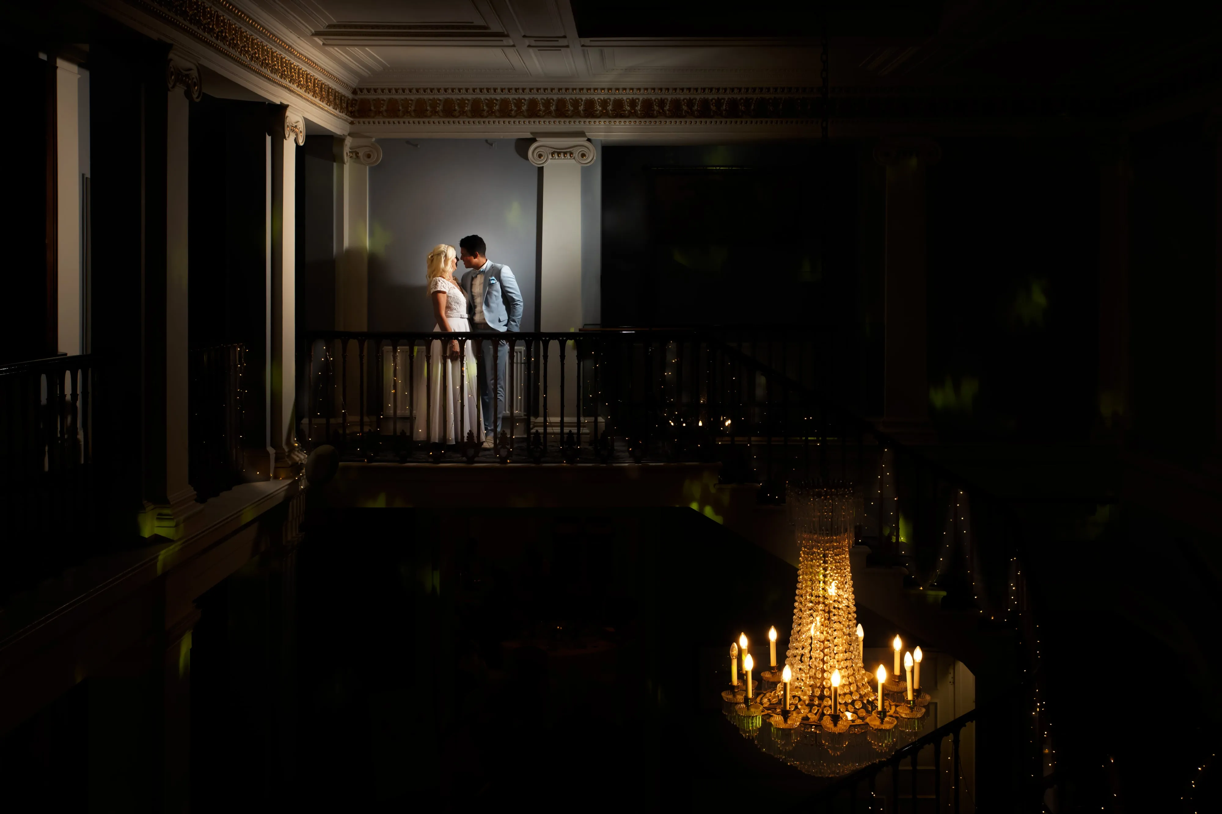 Bride and groom under umbrella in the rain at Dyrham Park