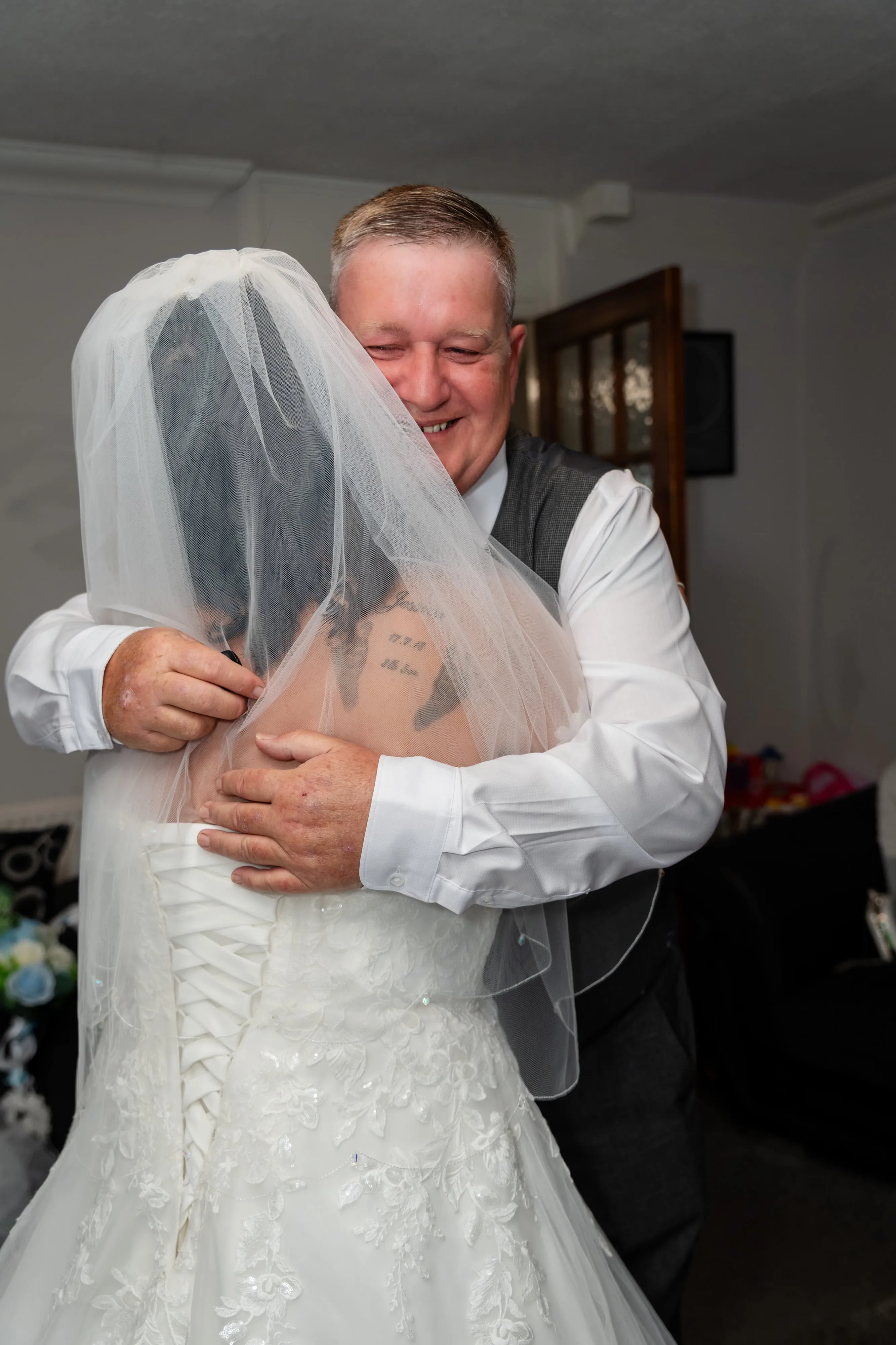 Father hugs his veiled daughter through joyful tears moments before leaving for the ceremony