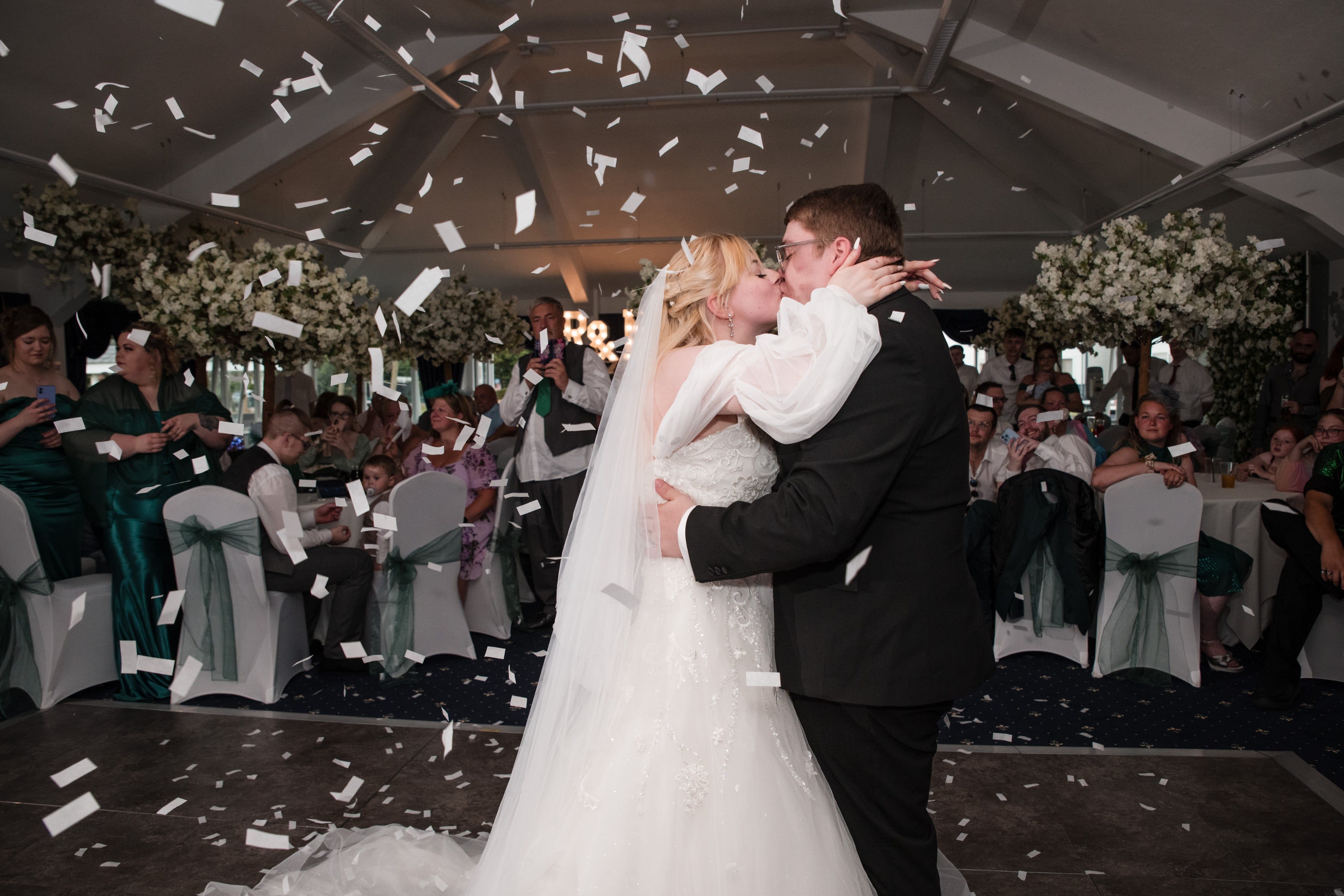 First dance under falling confetti in the lakeside suite