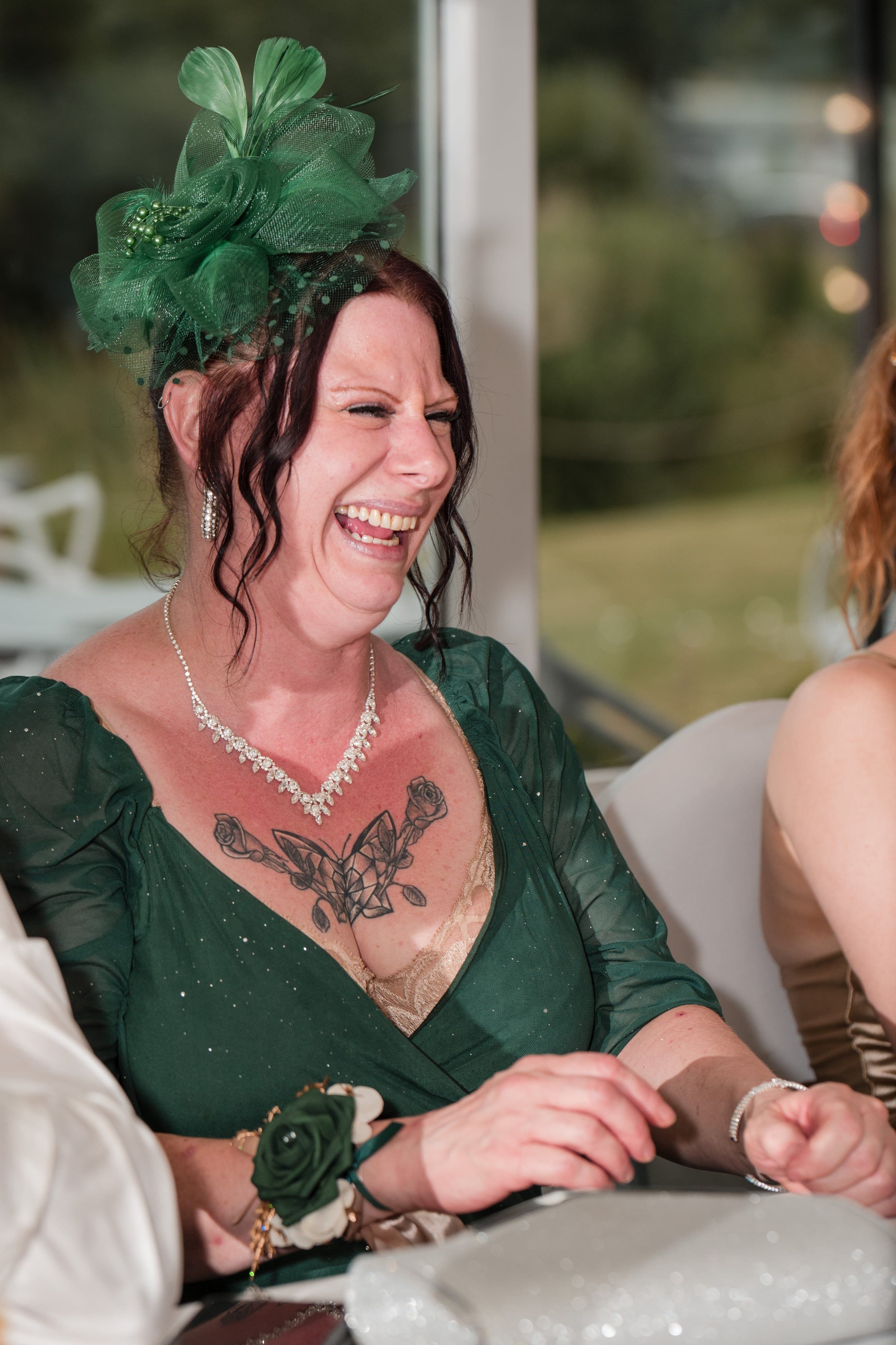 Guest in green laughs during the reception speeches
