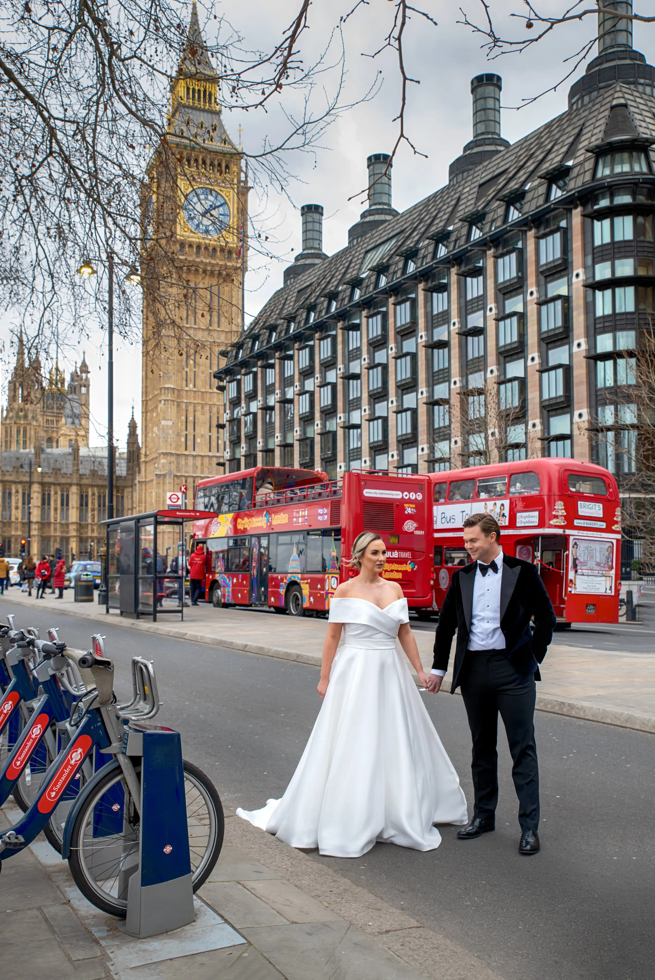 Bride and groom hold hands in front of Big Ben on a London wedding day