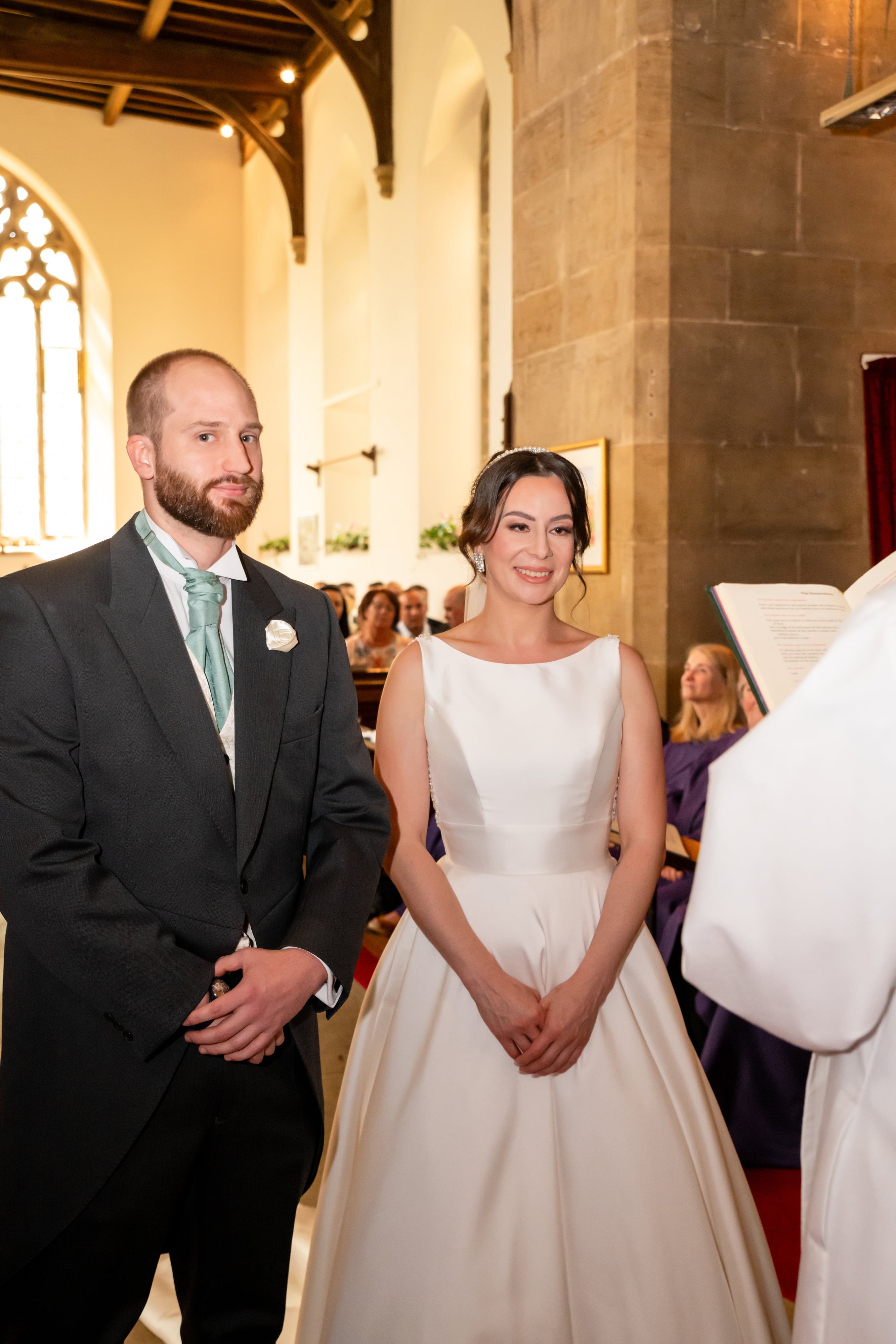 Bride and groom stand together at the altar of St Mary's Church