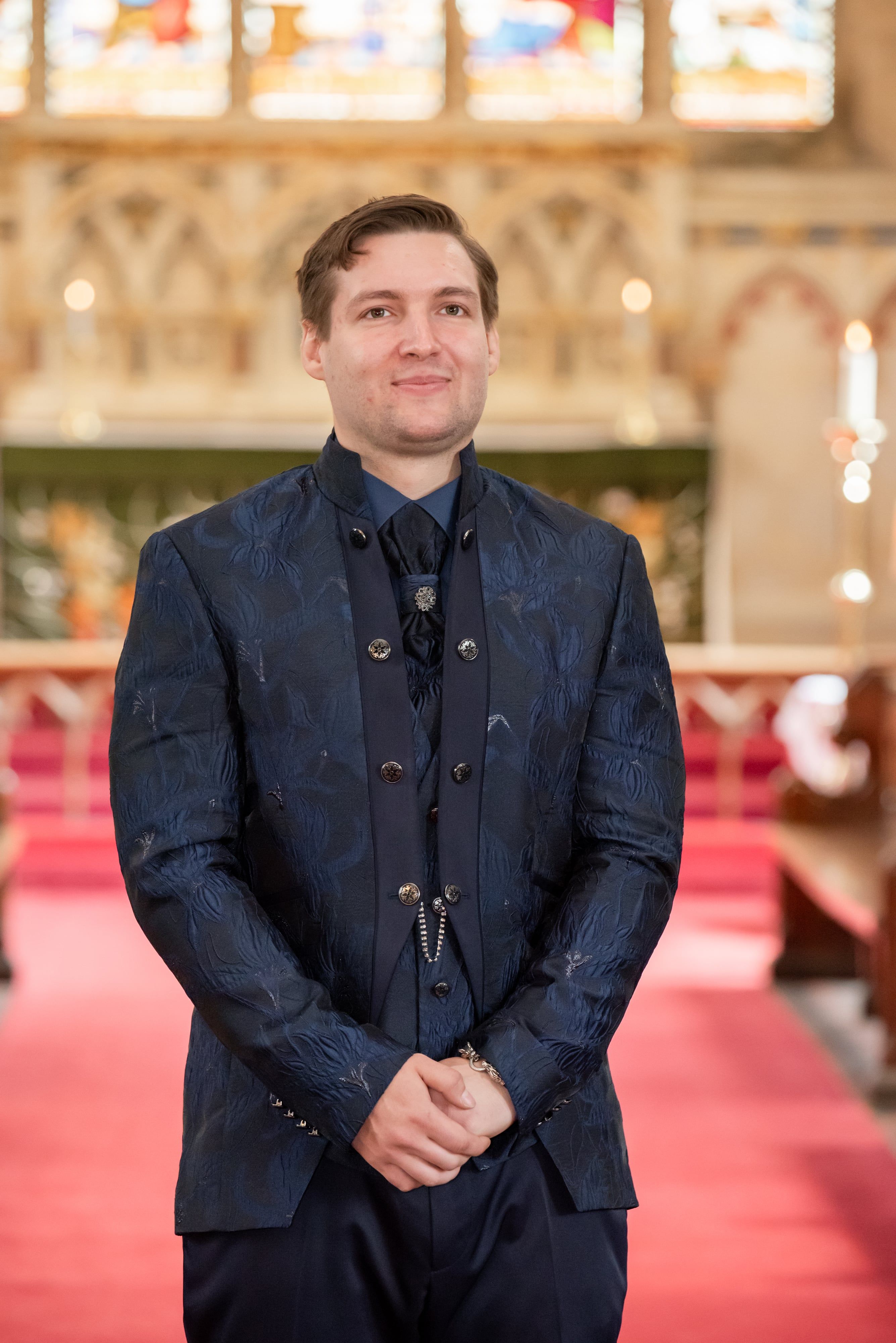 Groom stands composed at the altar before the ceremony begins